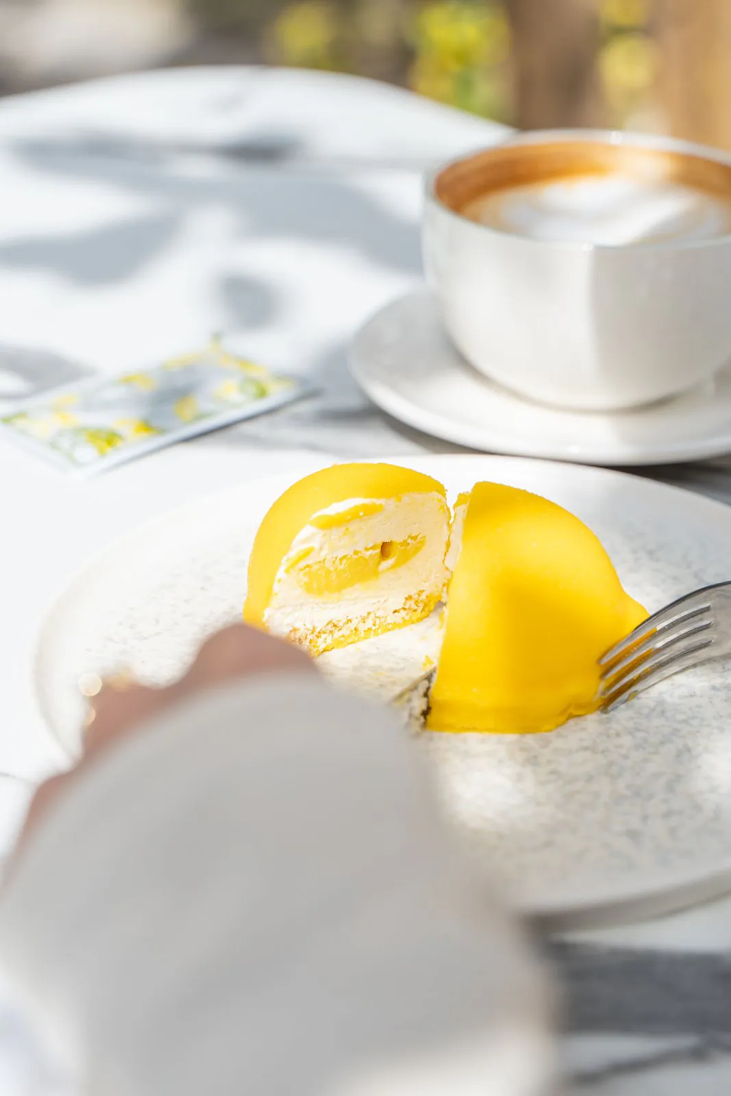 Lemon's Coffee — The lemon-shaped dessert and a coffee in the sunny courtyard